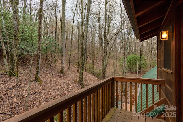 wooden terrace with a wooded view