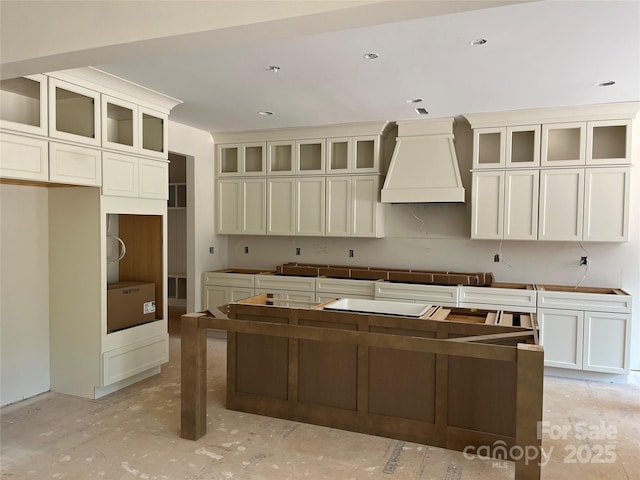 1204 Sage Pine Cir, Clover, SC 29710 - kitchen featuring premium range hood, a center island, and glass insert cabinets
