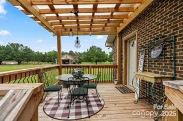 deck featuring outdoor dining area and a pergola