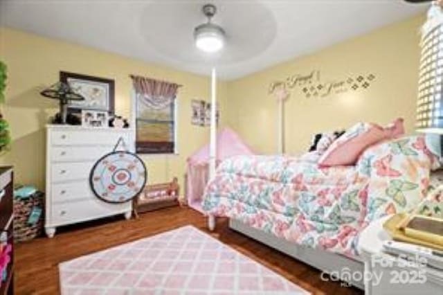 bedroom featuring multiple windows, wood finished floors, and ceiling fan