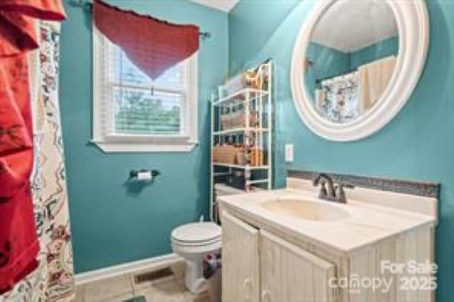 full bathroom featuring baseboards, toilet, tile patterned flooring, and vanity