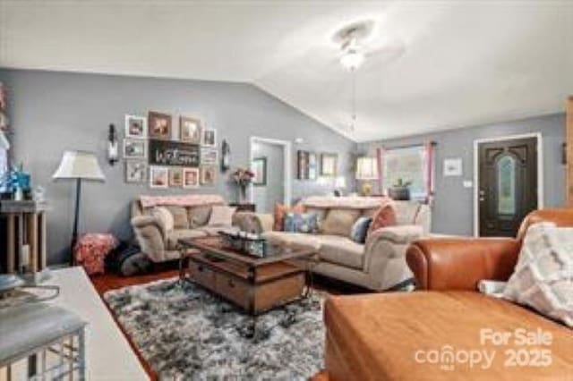 living room with lofted ceiling and a ceiling fan