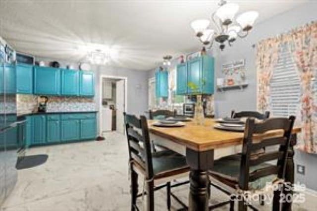 dining space featuring a notable chandelier