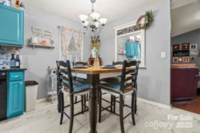 dining space featuring an inviting chandelier and baseboards