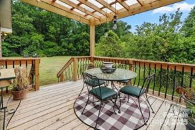 wooden terrace with a pergola and outdoor dining area