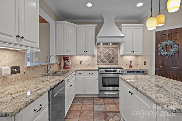 kitchen featuring custom exhaust hood, crown molding, stainless steel appliances, white cabinetry, and a sink