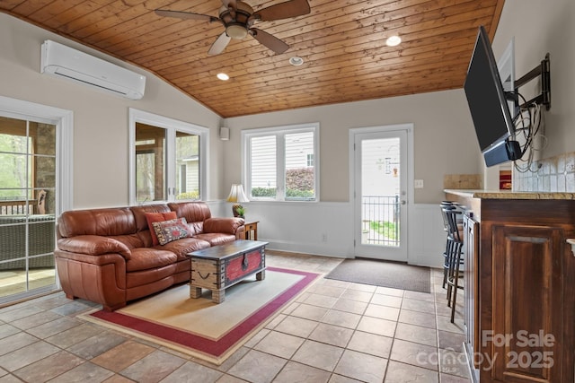 living area featuring a wall unit AC, lofted ceiling, wood ceiling, ceiling fan, and wainscoting