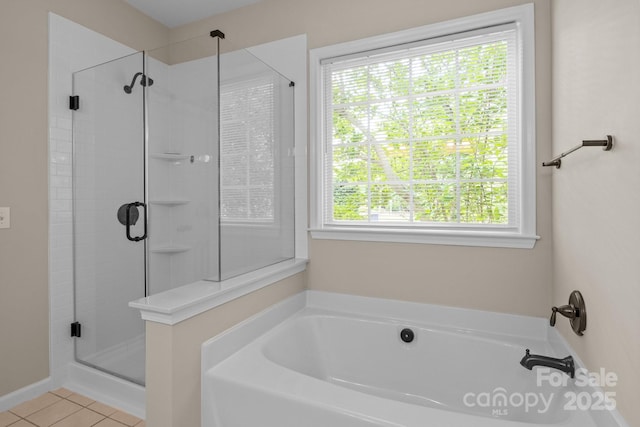 bathroom featuring a garden tub, tile patterned flooring, and a shower stall
