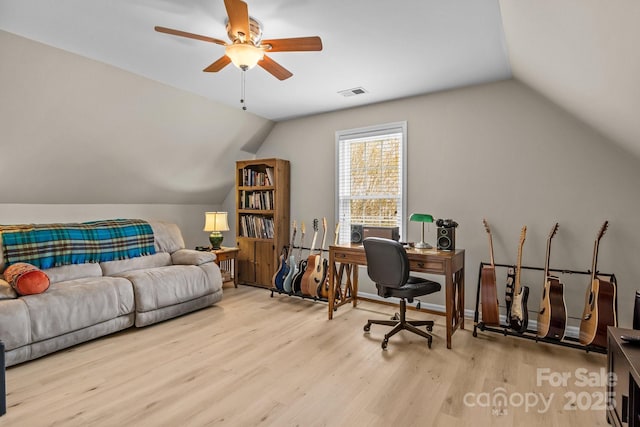 office space with vaulted ceiling, baseboards, visible vents, a ceiling fan, and wood finished floors