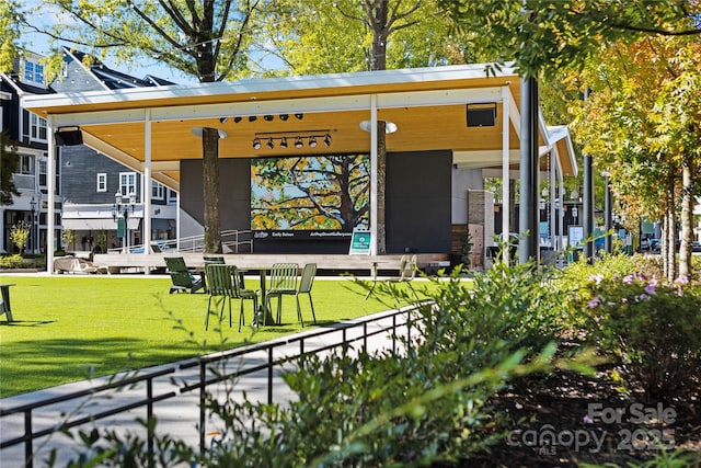 exterior space with fence and a lawn