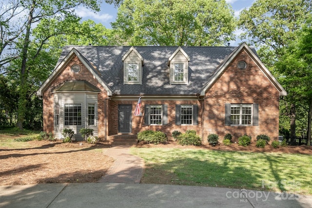 119 Lakenheath Ln, Matthews, NC 28105 - new england style home with brick siding, a front lawn, and a shingled roof
