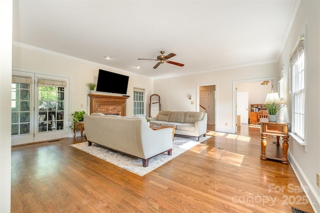 119 Lakenheath Ln, Matthews, NC 28105 - living room featuring ornamental molding, light wood-style flooring, and ceiling fan