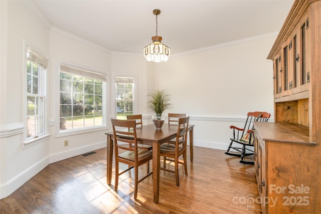 119 Lakenheath Ln, Matthews, NC 28105 - dining room with a notable chandelier, visible vents, ornamental molding, and wood finished floors