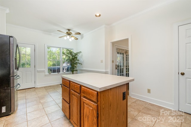 119 Lakenheath Ln, Matthews, NC 28105 - kitchen with light tile patterned flooring, crown molding, freestanding refrigerator, and ceiling fan