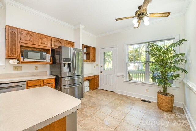 119 Lakenheath Ln, Matthews, NC 28105 - kitchen featuring crown molding, appliances with stainless steel finishes, light countertops, and visible vents