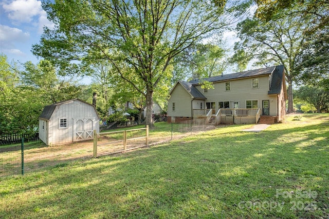 119 Lakenheath Ln, Matthews, NC 28105 - view of yard featuring a storage shed, an outdoor structure, fence, and a wooden deck