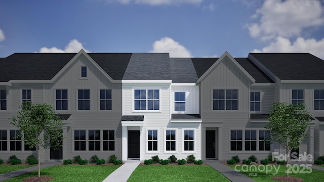 4724 Lakeview Rd Unit 26, Charlotte, NC 28216 - view of front of property with board and batten siding and a front lawn