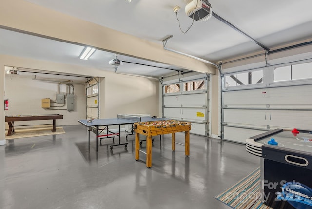 garage with a garage door opener and electric panel