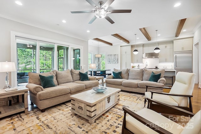 living room with ceiling fan, recessed lighting, light wood-style floors, and beamed ceiling