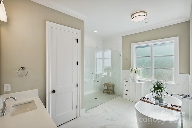 full bath with a stall shower, a freestanding tub, vanity, marble finish floor, and recessed lighting