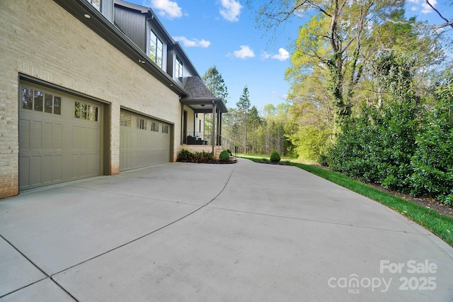 view of side of home with driveway