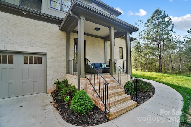 property entrance featuring brick siding, a porch, a garage, and a yard