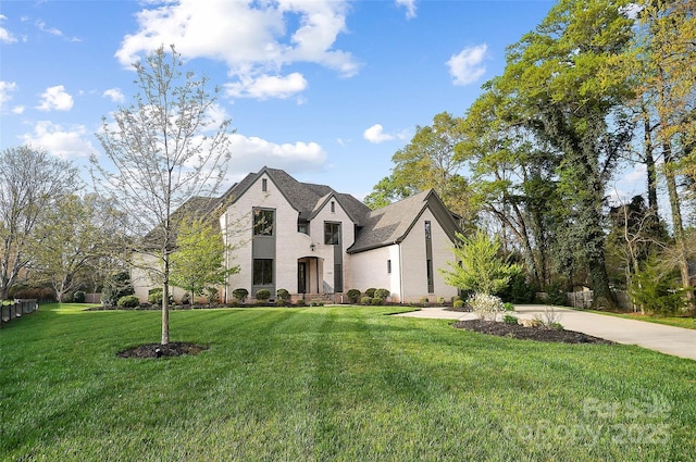 french country inspired facade featuring a front lawn