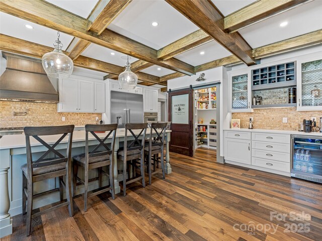 59 W Bradford Hill Rd, Mills River, NC 28759 - kitchen with decorative backsplash, stainless steel appliances, a barn door, wine cooler, and coffered ceiling