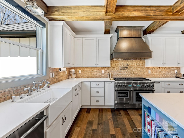 kitchen with light countertops, stainless steel appliances, white cabinetry, dark wood-type flooring, and custom exhaust hood