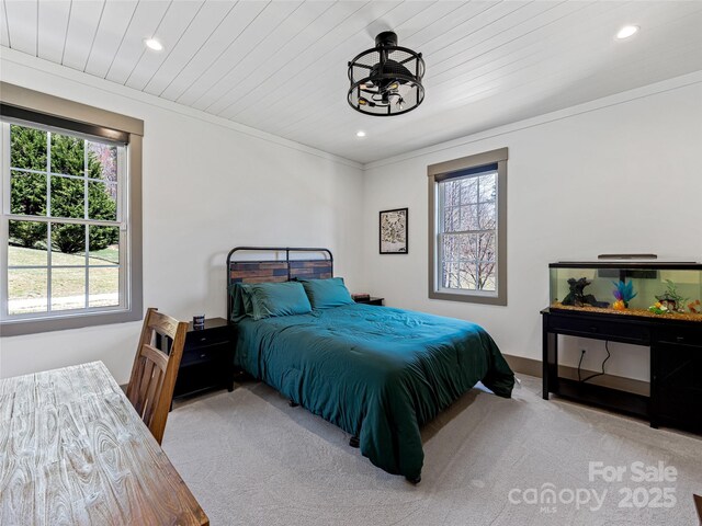 bedroom with recessed lighting, an inviting chandelier, and carpet