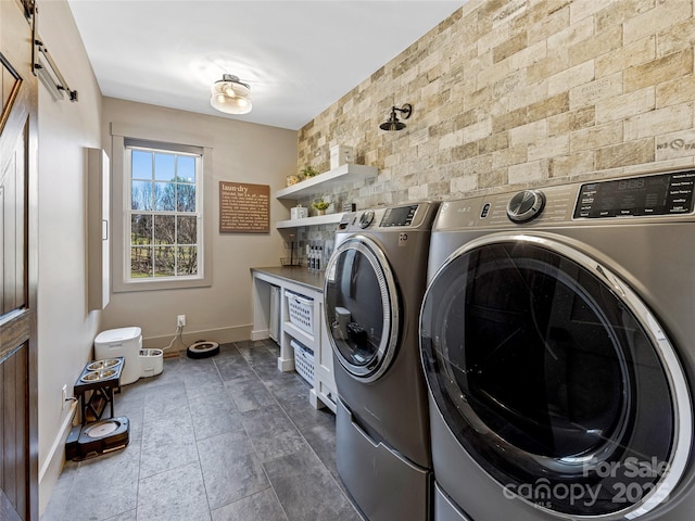 59 W Bradford Hill Rd, Mills River, NC 28759 - clothes washing area with baseboards, laundry area, a barn door, and washing machine and clothes dryer