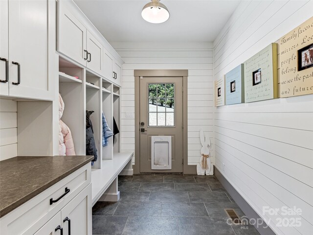 59 W Bradford Hill Rd, Mills River, NC 28759 - mudroom with wooden walls and stone finish floor