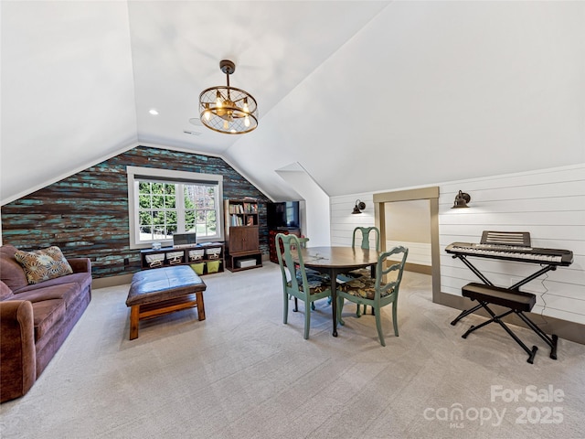 carpeted dining space with wood walls and lofted ceiling