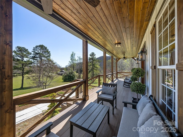 view of wooden balcony featuring a deck and outdoor lounge area