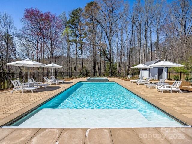 59 W Bradford Hill Rd, Mills River, NC 28759 - view of swimming pool with a patio, an outdoor structure, fence, and a pool with connected hot tub