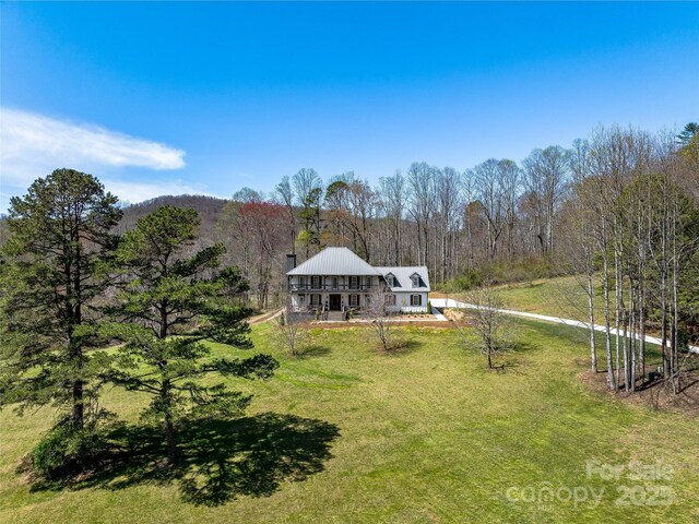 59 W Bradford Hill Rd, Mills River, NC 28759 - rear view of house featuring a forest view, a yard, and metal roof