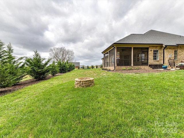 3012 Ocean Dr, Monroe, NC 28110 - view of yard featuring a sunroom and a fire pit