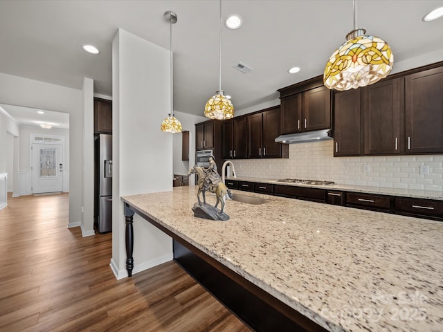 9582 Creighton Rd NW, Concord, NC 28027 - kitchen with visible vents, appliances with stainless steel finishes, under cabinet range hood, a sink, and backsplash