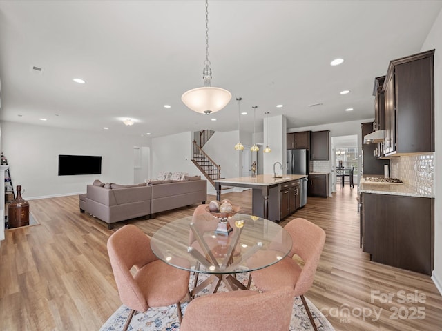 9582 Creighton Rd NW, Concord, NC 28027 - dining area with stairs, light wood-style floors, baseboards, and recessed lighting