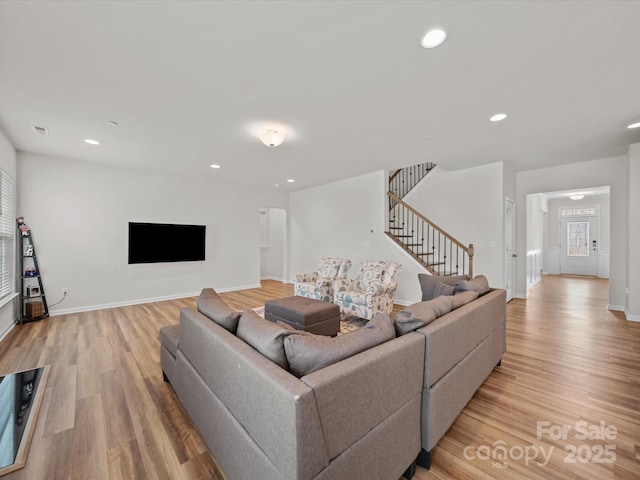 9582 Creighton Rd NW, Concord, NC 28027 - living room featuring light wood-style flooring, baseboards, stairway, and recessed lighting