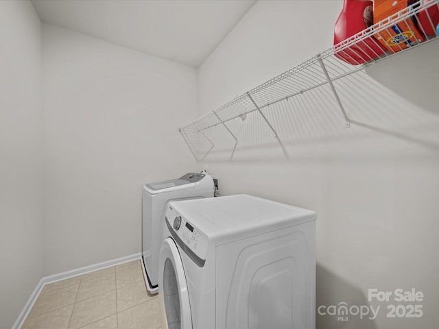 9582 Creighton Rd NW, Concord, NC 28027 - laundry area featuring washer and clothes dryer, laundry area, baseboards, and light tile patterned floors