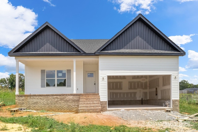 2508 Rock Dam Rd, Lincolnton, NC 28092 - view of front of property featuring board and batten siding, a porch, brick siding, and an attached garage