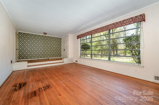340 Sardis Rd N, Charlotte, NC 28270 - spare room featuring plenty of natural light, an accent wall, and wood finished floors