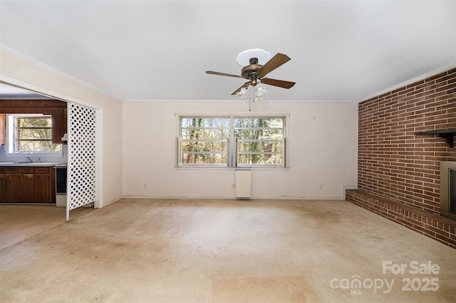 340 Sardis Rd N, Charlotte, NC 28270 - unfurnished living room with ceiling fan, brick wall, crown molding, and light colored carpet