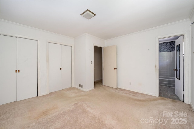 340 Sardis Rd N, Charlotte, NC 28270 - unfurnished bedroom with ensuite bathroom, visible vents, two closets, ornamental molding, and carpet floors