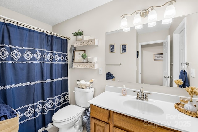 bathroom with a shower with shower curtain, toilet, vanity, and a textured ceiling