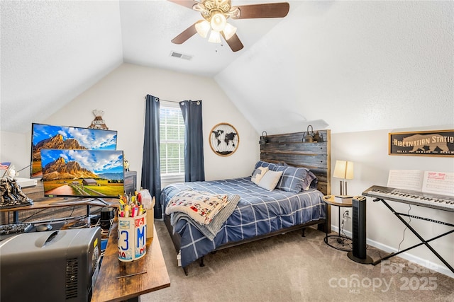 carpeted bedroom with a textured ceiling, ceiling fan, visible vents, and vaulted ceiling