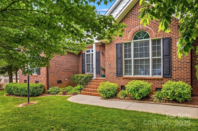 4159 Isle Of Pines Dr, Denver, NC 28037 - view of exterior entry featuring brick siding, a lawn, and crawl space