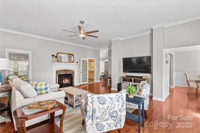 4159 Isle Of Pines Dr, Denver, NC 28037 - living room featuring ornamental molding, a fireplace, wood finished floors, ceiling fan, and baseboards