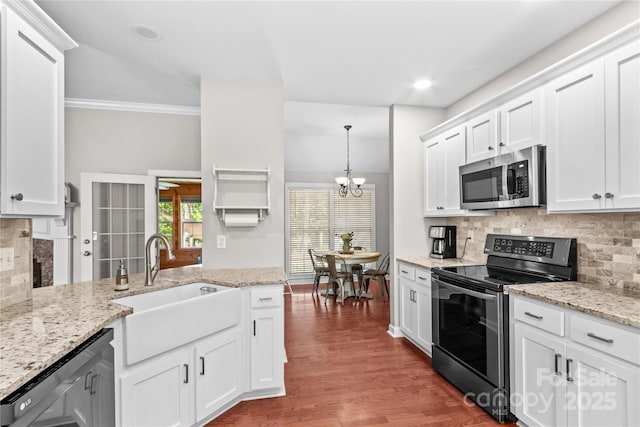 4159 Isle Of Pines Dr, Denver, NC 28037 - kitchen with stainless steel appliances, a sink, backsplash, a chandelier, and wood finished floors